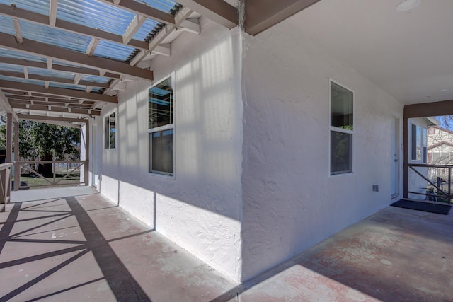 view of home's exterior featuring a patio area, a pergola, and stucco siding