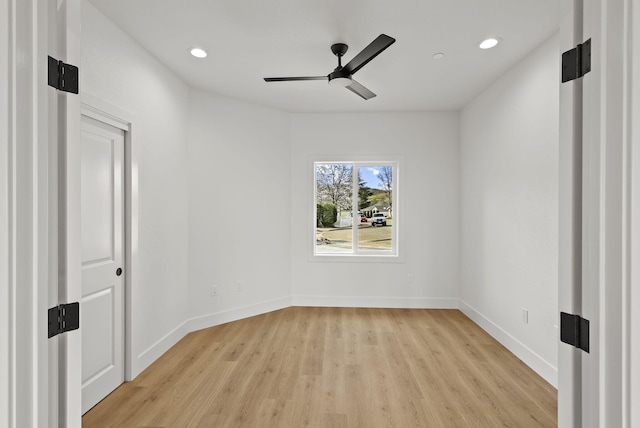 spare room with a ceiling fan, recessed lighting, light wood-style flooring, and baseboards