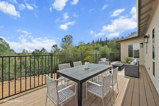 wooden terrace featuring outdoor dining space and outdoor lounge area