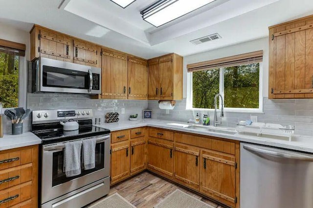 18260 Racoon Dr, Lakehead, CA 96051 - kitchen with a wealth of natural light, a raised ceiling, visible vents, appliances with stainless steel finishes, and a sink
