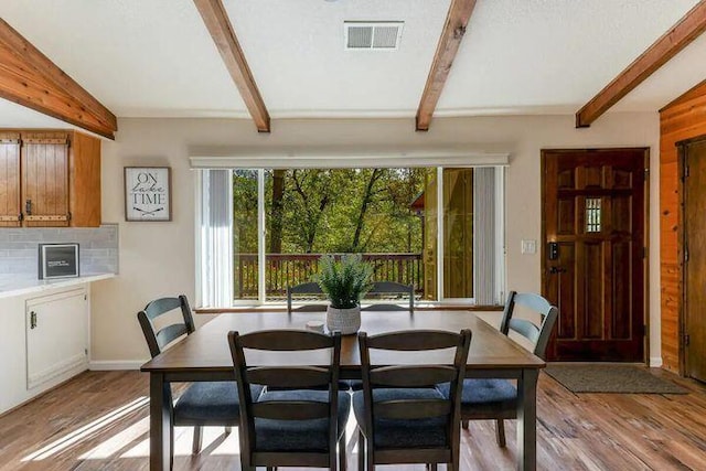 18260 Racoon Dr, Lakehead, CA 96051 - dining area featuring baseboards, beam ceiling, visible vents, and light wood-style floors