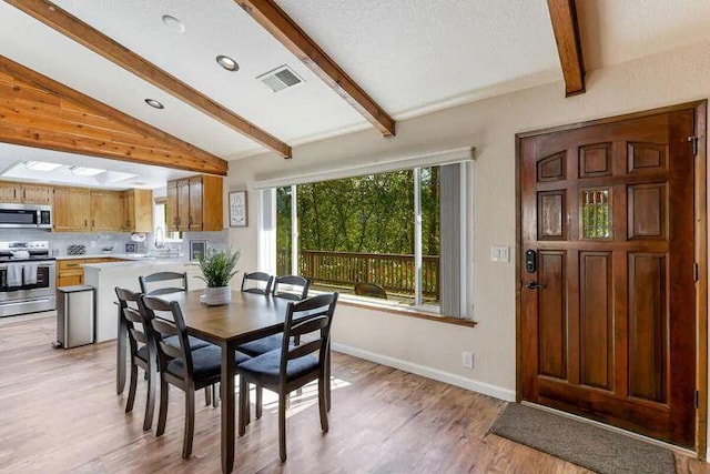18260 Racoon Dr, Lakehead, CA 96051 - dining room with recessed lighting, visible vents, lofted ceiling with beams, light wood-style floors, and baseboards