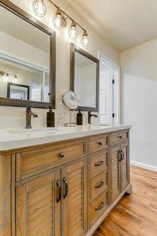 18260 Racoon Dr, Lakehead, CA 96051 - full bath featuring a sink, double vanity, wood finished floors, and baseboards