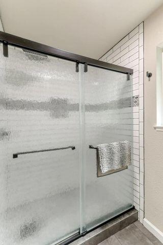 18260 Racoon Dr, Lakehead, CA 96051 - full bath featuring a stall shower, tile patterned flooring, and baseboards