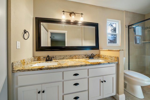 full bath with toilet, a shower stall, and a sink