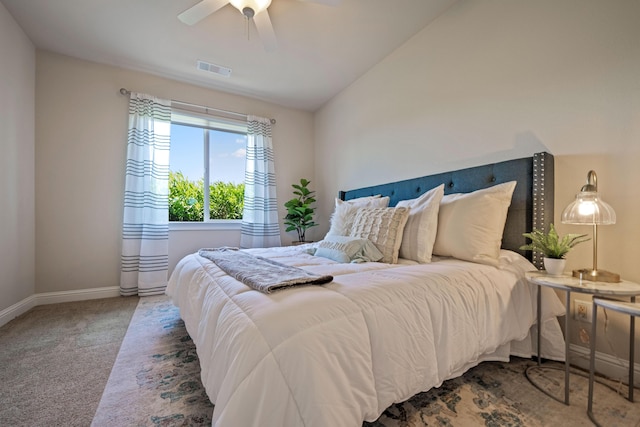 bedroom with ceiling fan, visible vents, baseboards, vaulted ceiling, and carpet