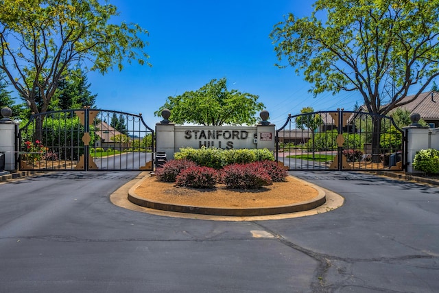 community sign featuring a gate