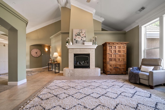 living room with a premium fireplace, visible vents, ornamental molding, and tile patterned floors