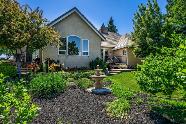 view of front of property featuring a tile roof and stucco siding