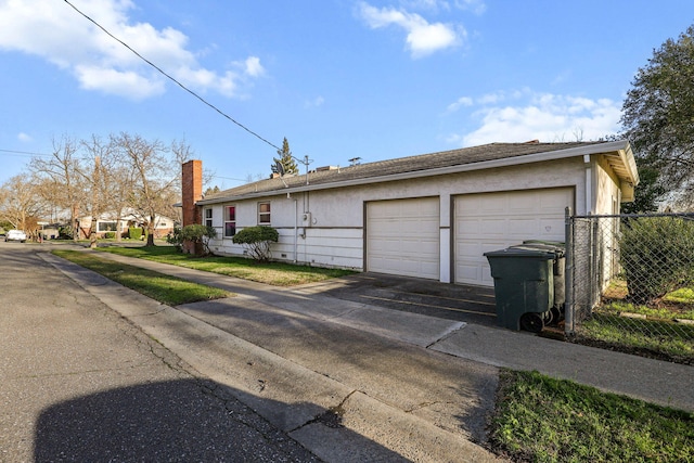 view of front of home with fence and stucco siding