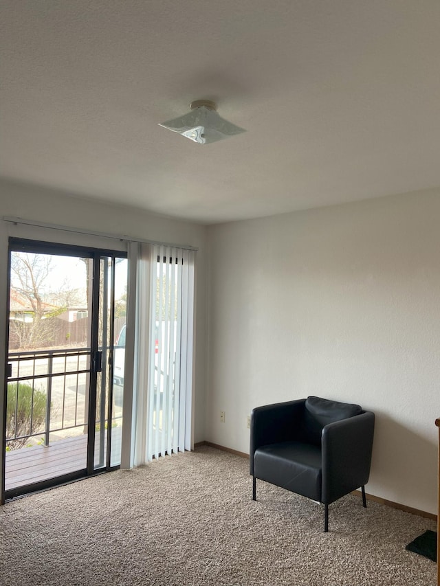 sitting room with carpet flooring and baseboards