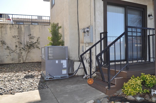 exterior space featuring central AC and stucco siding