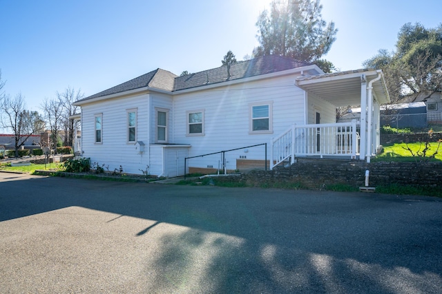 exterior space with a shingled roof