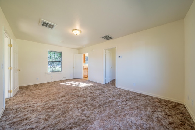 unfurnished bedroom featuring carpet floors, visible vents, and baseboards