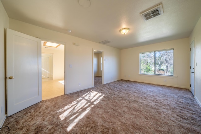 unfurnished bedroom with baseboards, visible vents, and carpet flooring