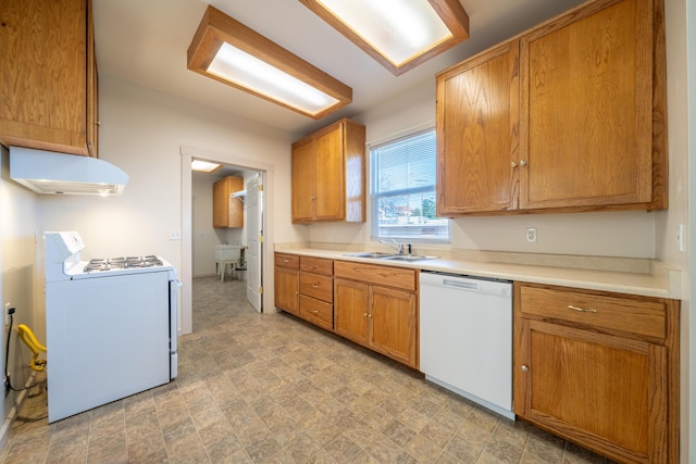 kitchen with gas range oven, white dishwasher, extractor fan, light countertops, and a sink