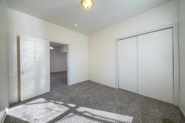 unfurnished bedroom featuring carpet, a closet, and visible vents