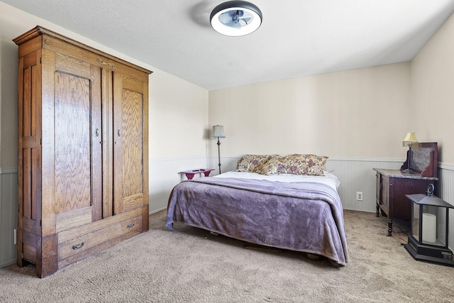 carpeted bedroom with wainscoting