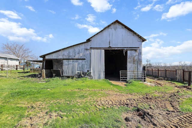 view of outbuilding with fence and an outdoor structure