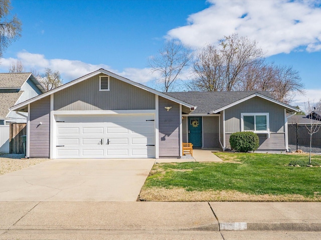 ranch-style home with a front lawn, an attached garage, fence, and concrete driveway