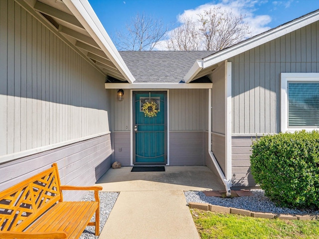 property entrance with a shingled roof