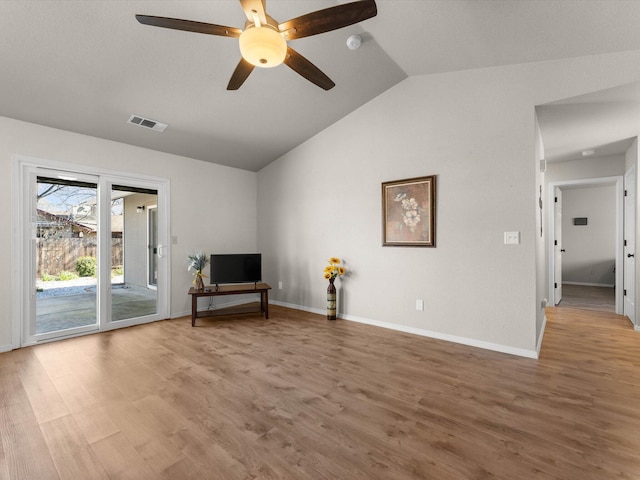 unfurnished room featuring visible vents, baseboards, wood finished floors, and vaulted ceiling