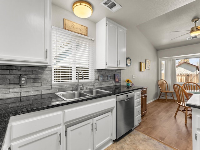 kitchen featuring visible vents, white cabinets, dishwasher, and a sink