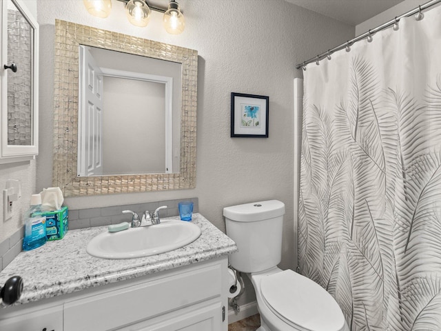 full bathroom with toilet, vanity, a shower with curtain, and a textured wall