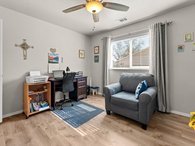 office area featuring a ceiling fan, visible vents, and light wood-type flooring