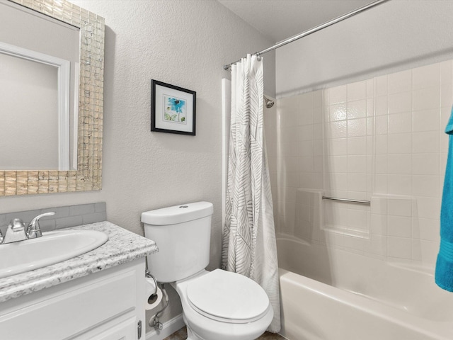 bathroom featuring shower / bath combination with curtain, toilet, vanity, and a textured wall