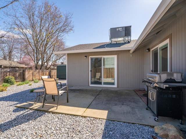 view of patio / terrace with cooling unit, fence, and a grill