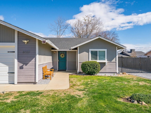 ranch-style house featuring a front yard, fence, a garage, and roof with shingles