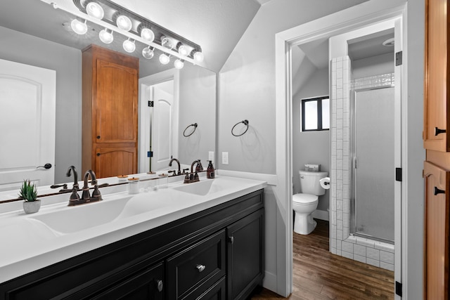 3300 Forest Hills Dr, Redding, CA 96002 - full bath featuring double vanity, toilet, a stall shower, a sink, and wood finished floors