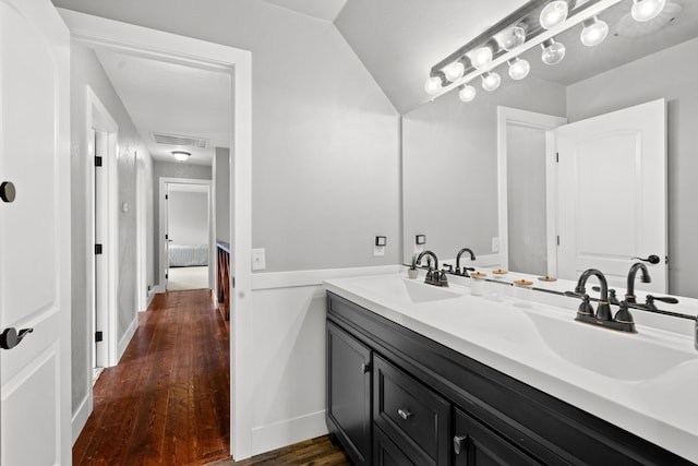 3300 Forest Hills Dr, Redding, CA 96002 - bathroom with lofted ceiling, visible vents, a sink, and wood finished floors