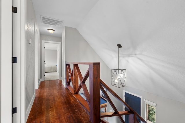 3300 Forest Hills Dr, Redding, CA 96002 - corridor featuring visible vents, lofted ceiling, dark wood-type flooring, an inviting chandelier, and an upstairs landing