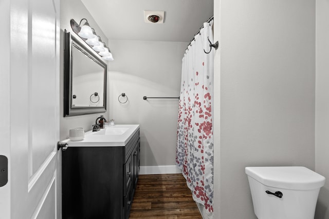 3300 Forest Hills Dr, Redding, CA 96002 - full bathroom featuring baseboards, toilet, a shower with curtain, wood finished floors, and vanity