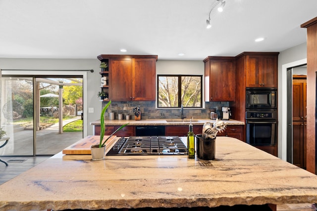 3300 Forest Hills Dr, Redding, CA 96002 - kitchen featuring light stone countertops, black appliances, plenty of natural light, and a sink