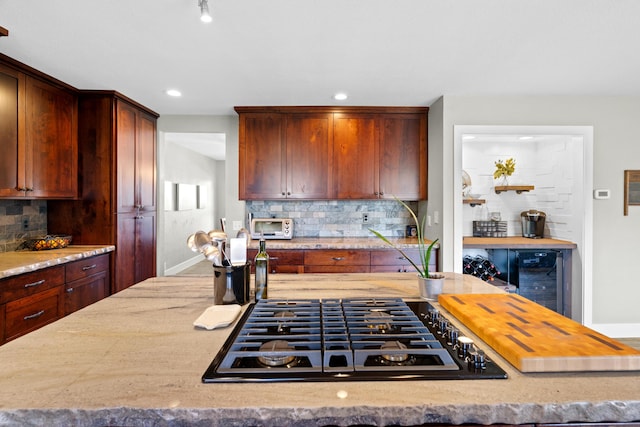 3300 Forest Hills Dr, Redding, CA 96002 - kitchen with black gas cooktop, tasteful backsplash, a toaster, and light stone countertops