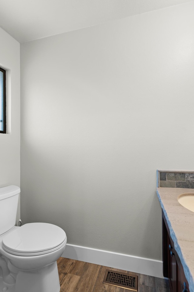 3300 Forest Hills Dr, Redding, CA 96002 - half bath featuring baseboards, visible vents, toilet, wood finished floors, and vanity