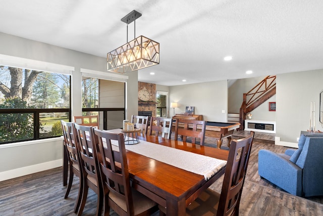 3300 Forest Hills Dr, Redding, CA 96002 - dining area featuring a stone fireplace, recessed lighting, wood finished floors, and baseboards