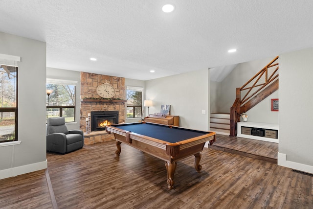 3300 Forest Hills Dr, Redding, CA 96002 - playroom with billiards, a stone fireplace, a textured ceiling, and wood finished floors