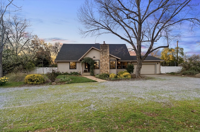 mid-century home featuring crawl space, driveway, a chimney, and fence