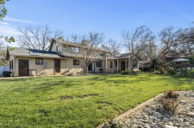 3300 Forest Hills Dr, Redding, CA 96002 - back of property featuring central AC, fence, a yard, a chimney, and a patio area