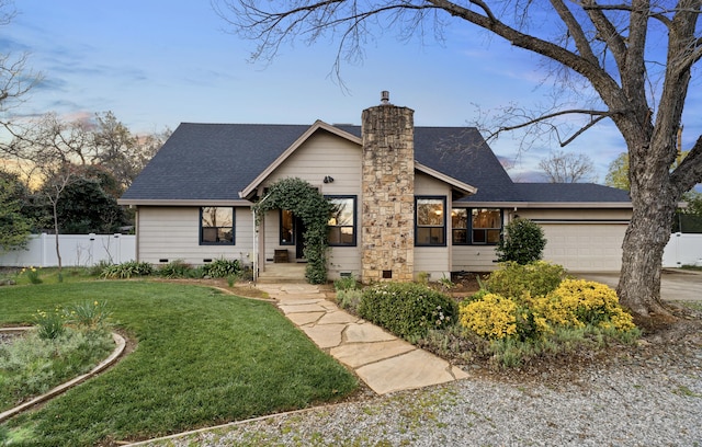 view of front of home featuring a chimney, an attached garage, a front yard, crawl space, and fence