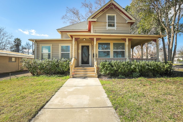 victorian home featuring covered porch and a front yard