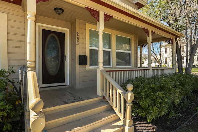 view of exterior entry with a porch