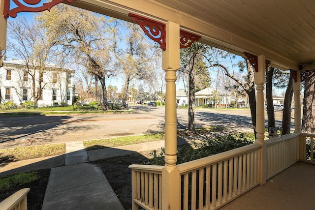 view of patio featuring covered porch and a residential view