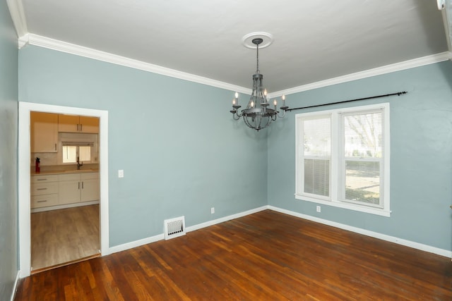 unfurnished room featuring ornamental molding, dark wood-type flooring, a sink, and visible vents