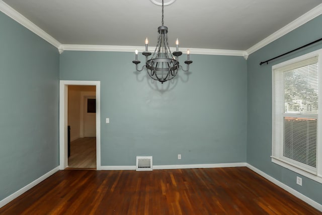 empty room featuring a chandelier, wood finished floors, visible vents, baseboards, and crown molding