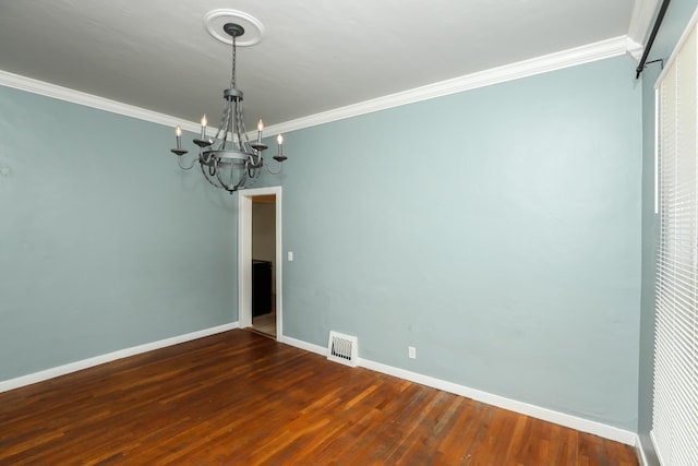 spare room with baseboards, visible vents, dark wood finished floors, and ornamental molding